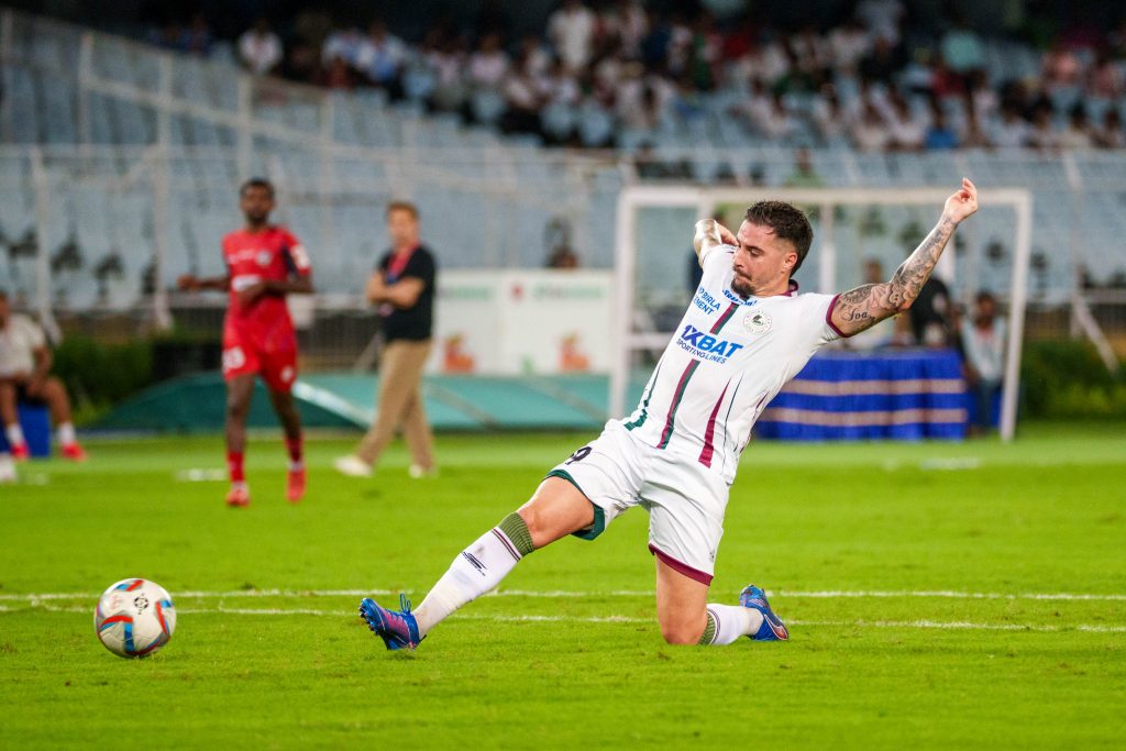 Maclaren taking goal scoring shot against Diamond Harbour FC